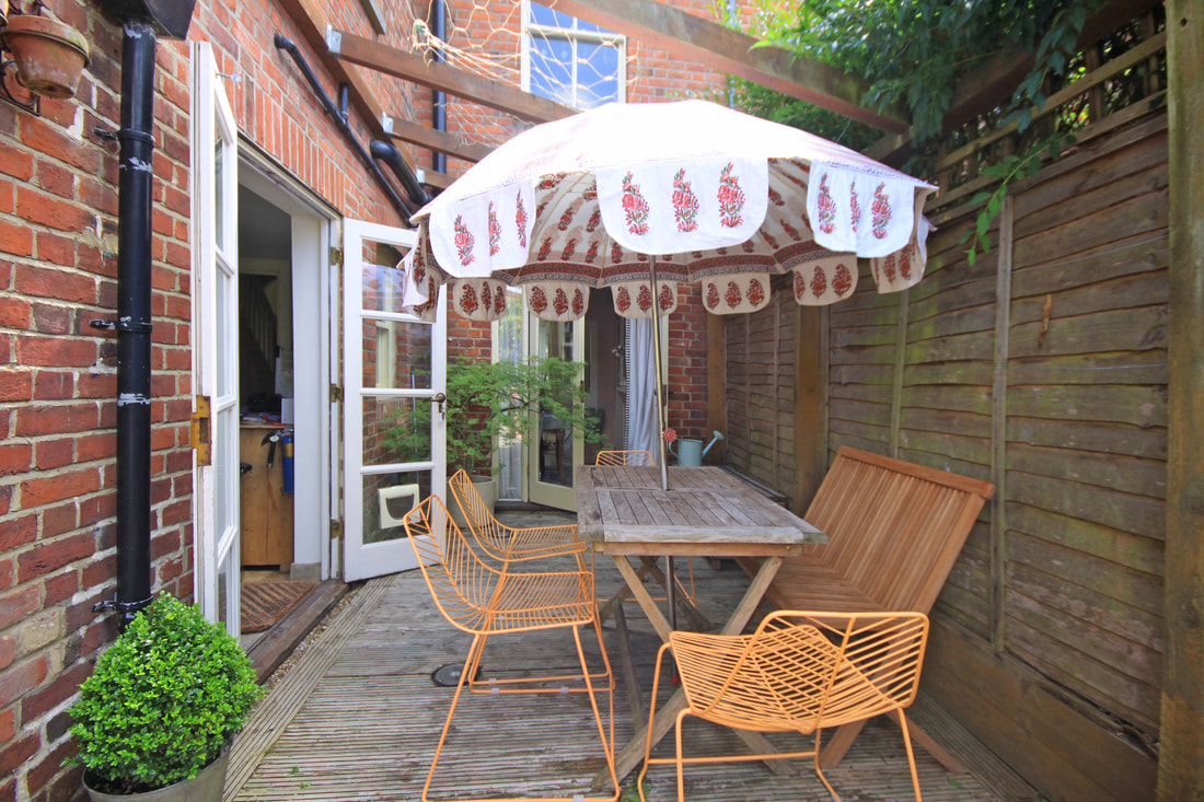 designer leaf garden chair, block printed parasol, pretty garden courtyard victorian back garden